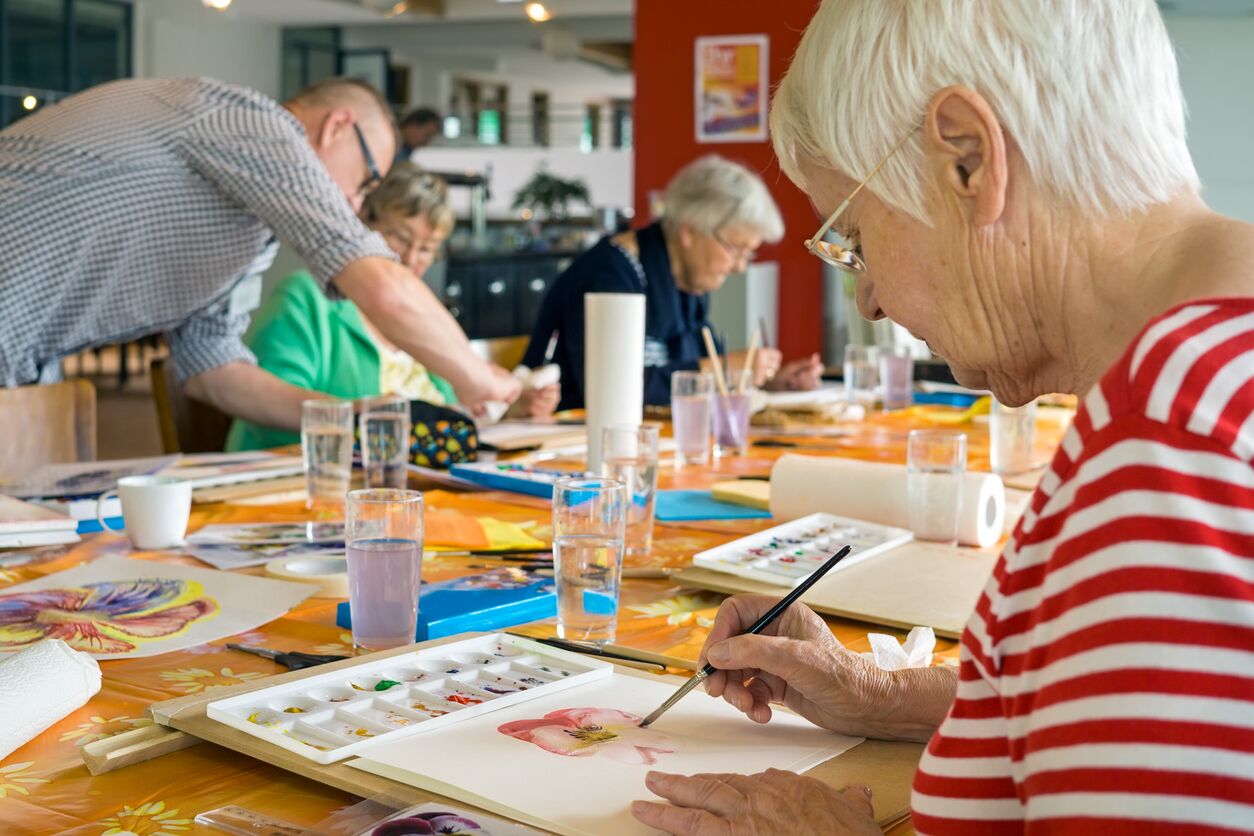 Older adults and caregivers organizing creative activity supplies for senior programs in Los Angeles
