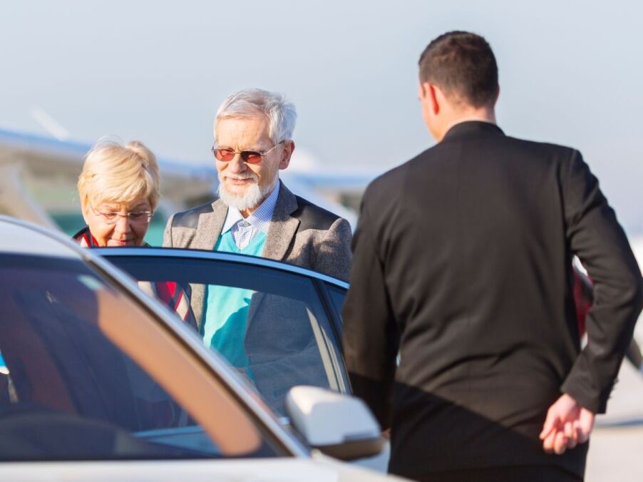 Older adult preparing for a senior transportation ride with caregiver support